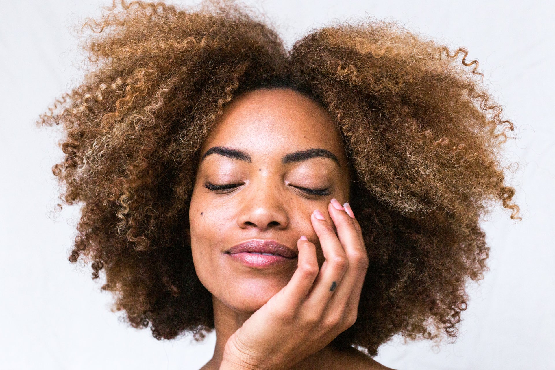 Photo of a woman holding her face representing youthful skin from consuming marine collagen