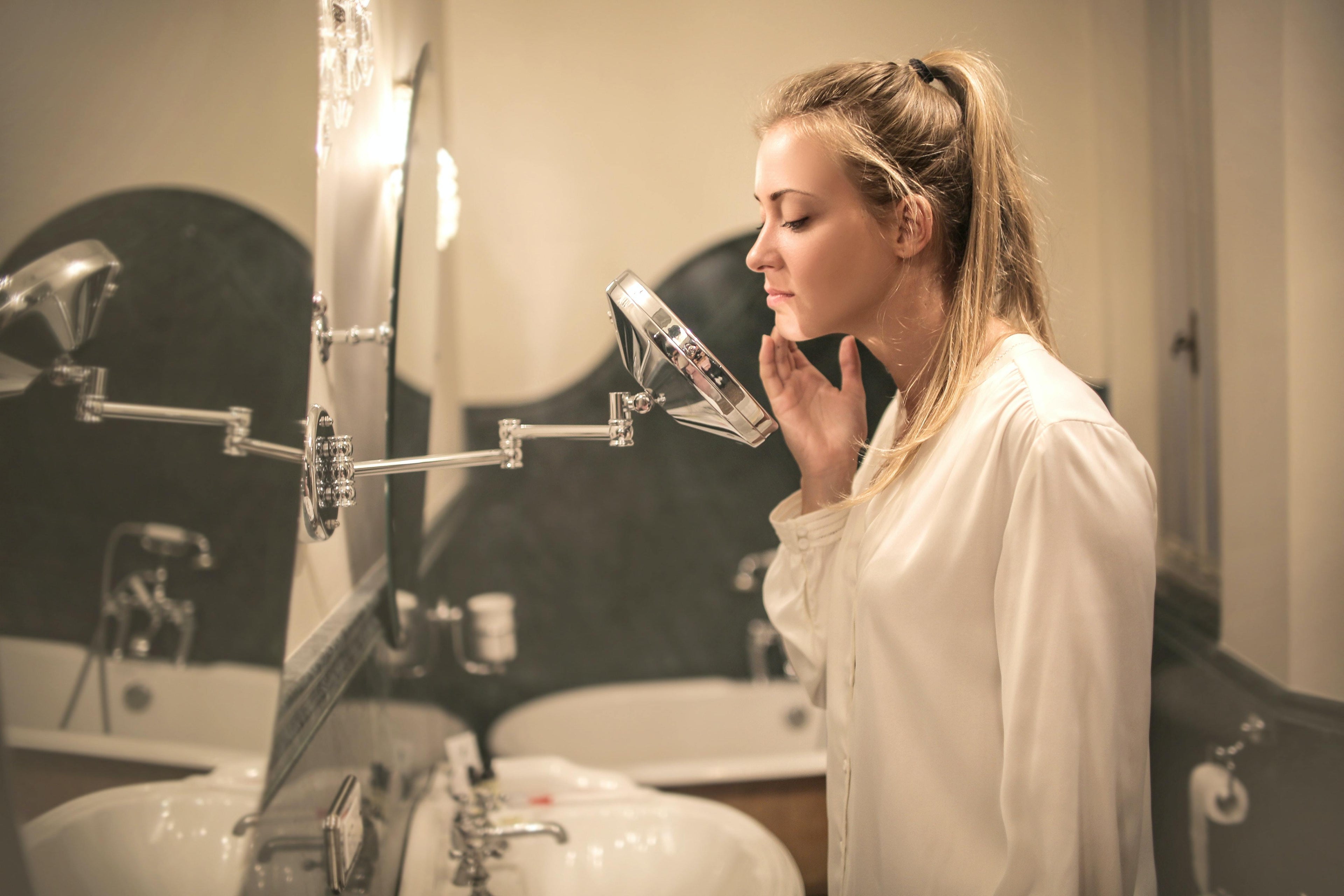 woman looking in mirror